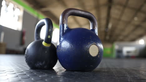 panning footage of kettlebells on a gym floor