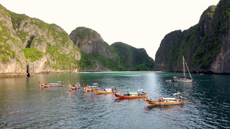 Tourists-Swimming-from-Long-Tail-Boats-Near-Tropical-Island