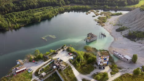 Aerial-landscape-Sand-Hills-of-Quarry-With-a-Pond-and-Abandoned-Prison-in-Rummu-Estonia-Europe