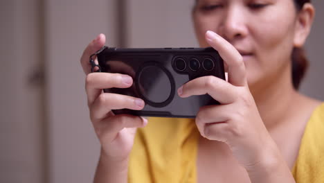 Woman-Enjoying-Smartphone-Games-at-Home