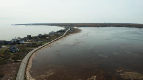 Long-coastal-road-on-a-narrow-land,-Biddeford-Pool,-Maine,-aerial-shot