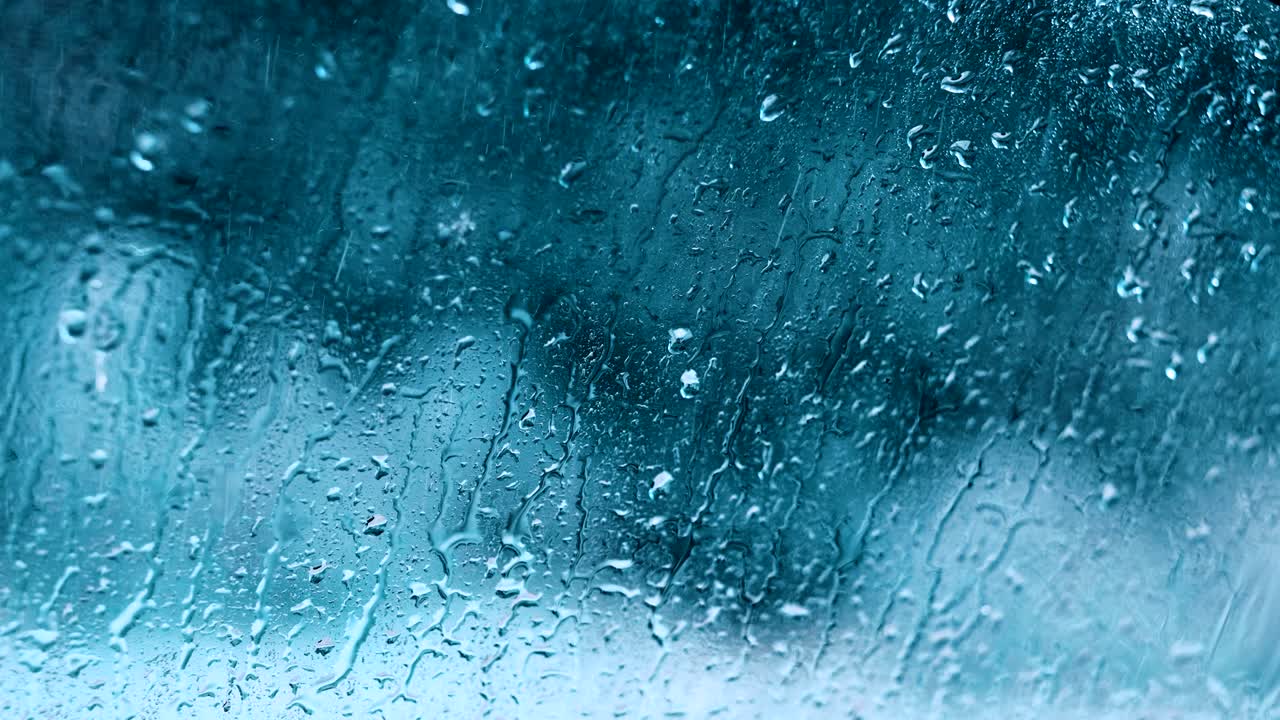 gotas de lluvia movimiento agua fondo de vidrio azul