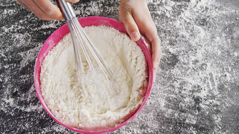 woman whisking flour in bowl 4k