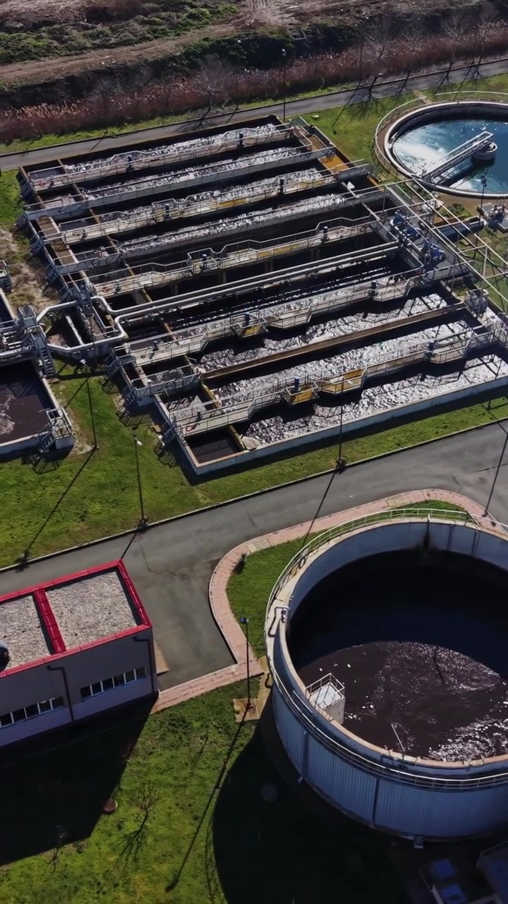 Water treatment facility in operation with many tanks and buildings