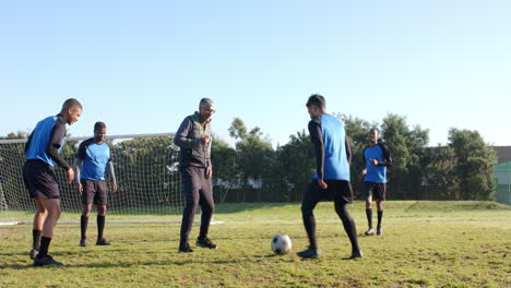 playing soccer, team practicing on field with goal in background