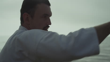 closeup fighter training hands punches at sunset. man practicing martial arts.