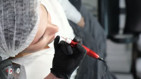 Woman undergoing permanent eyebrow makeup procedure