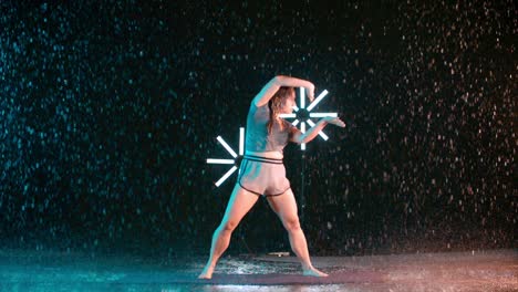 female dancer martial arts movement in the rain, slow motion effect