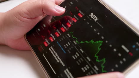 an individual browsing a smart electronic tablet to check the latest information on the stock market