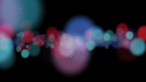 animación de manchas de luz que caen sobre un fondo negro.
