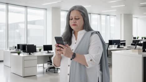 Happy-Indian-senior-businesswoman-chatting-on-phone