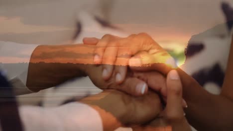 animation of landscape over senior biracial couple holding hands