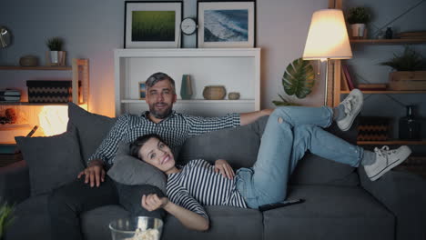 couple relaxing and watching movie at home