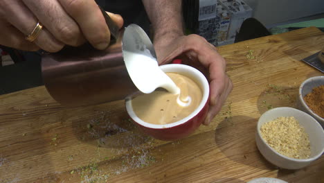preparing a latte or cappuccino with coffee art