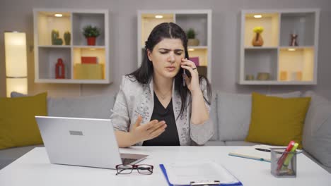 Home-office-worker-woman-phone-angry-performs-business-call.