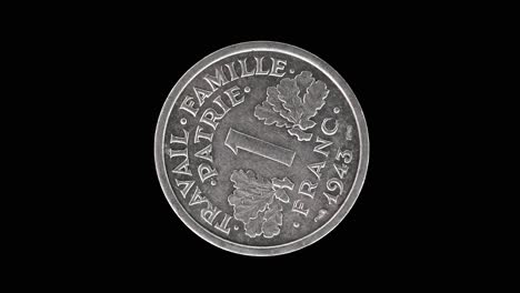 france 1943 1 franc coin reverse with oak leaves and denomination rotating on black background