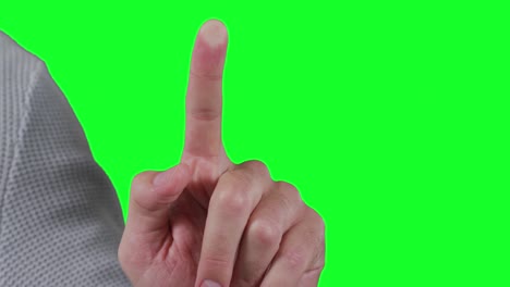 caucasian man pointing on green background