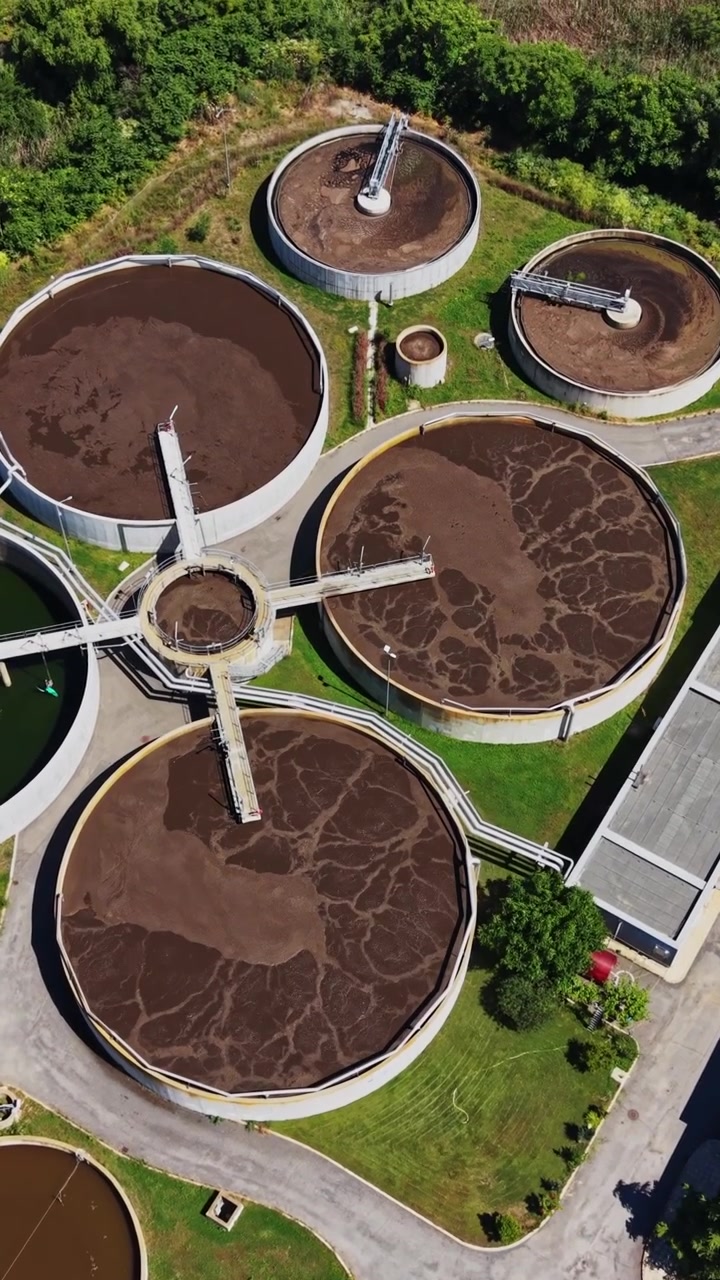 Water treatment facility near a river shows various processes in action