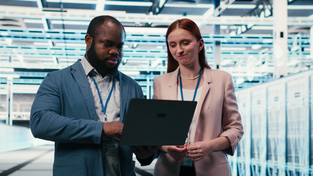 Diverse IT Team Analyzing Data on Laptop in Data Center