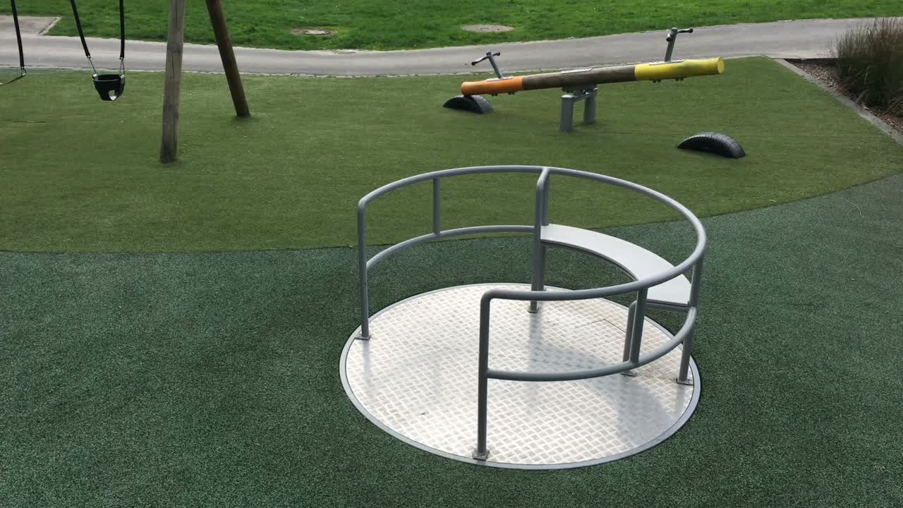 Merry Go Round carousel spinning empty in playground park