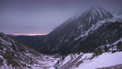 slow cinematic zoom down snowy mountains in the pyrenees