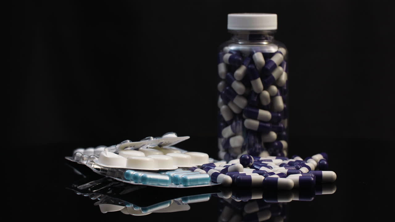 회전하는 항생제 앰플이 있는 알약 물집의 의학 약국 개념