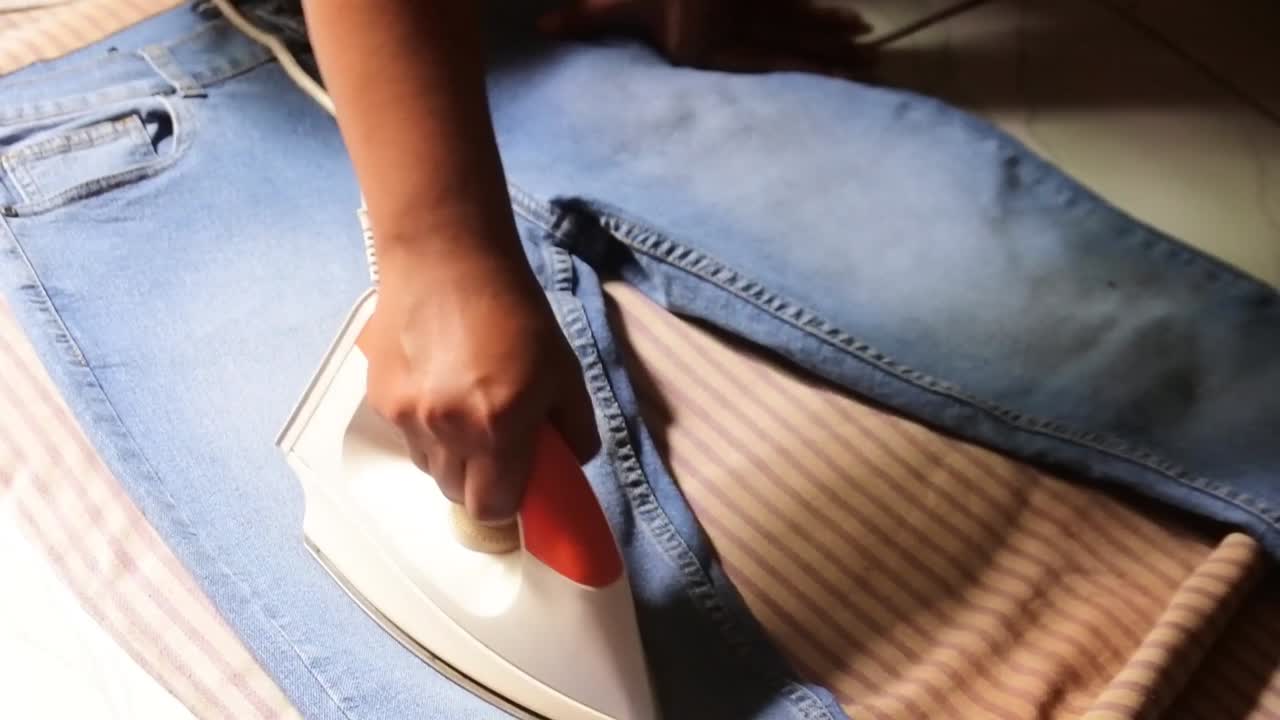 hand ironing jeans laundry business concept