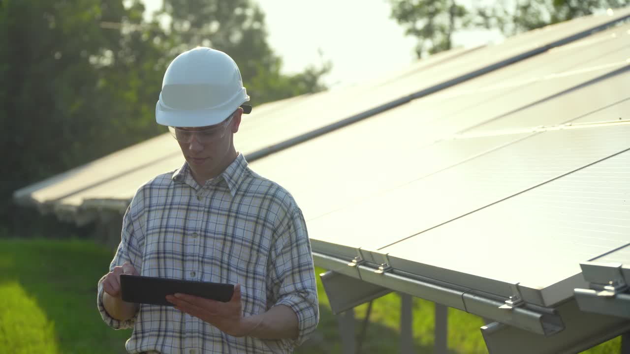 Solar panel technician working with solar panels. Concept renewable energy