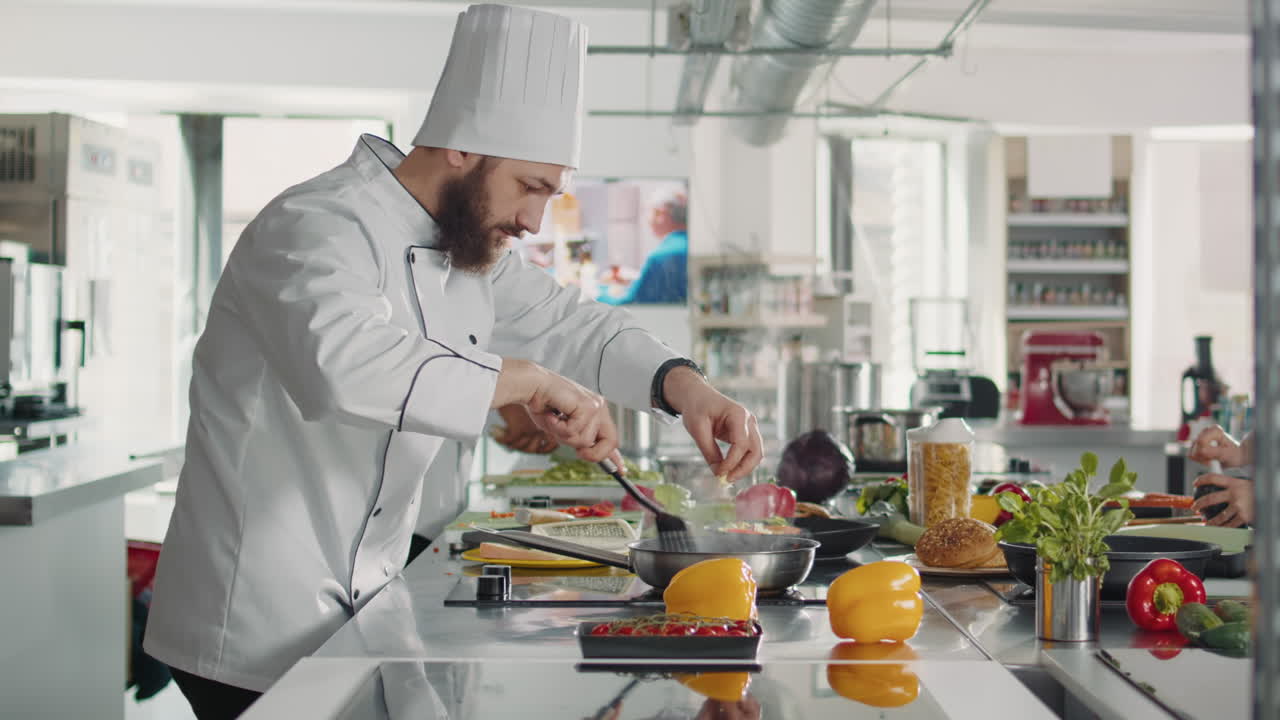 Professional chef adding grated parmesan cheese on food in pan