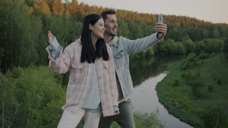 couple taking a selfie by the river