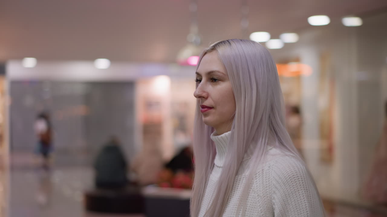 side view fashionista walking toward boutique window, placing hands on glass display in admiration, soft lighting reflecting boutique interior, blurred background models and lights creating elegant