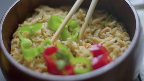 close-up bowl of vegan tasty delicious ramen with organic fresh green and red cucumber healthy balanced diet