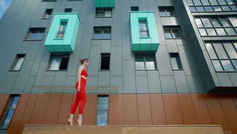 woman performing yoga and acrobatics in urban setting