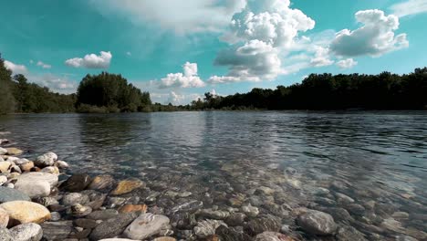 river stream running fresh water on pebble stone, perfect sunny summer day in pure nature