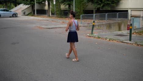 young woman walking on a city street