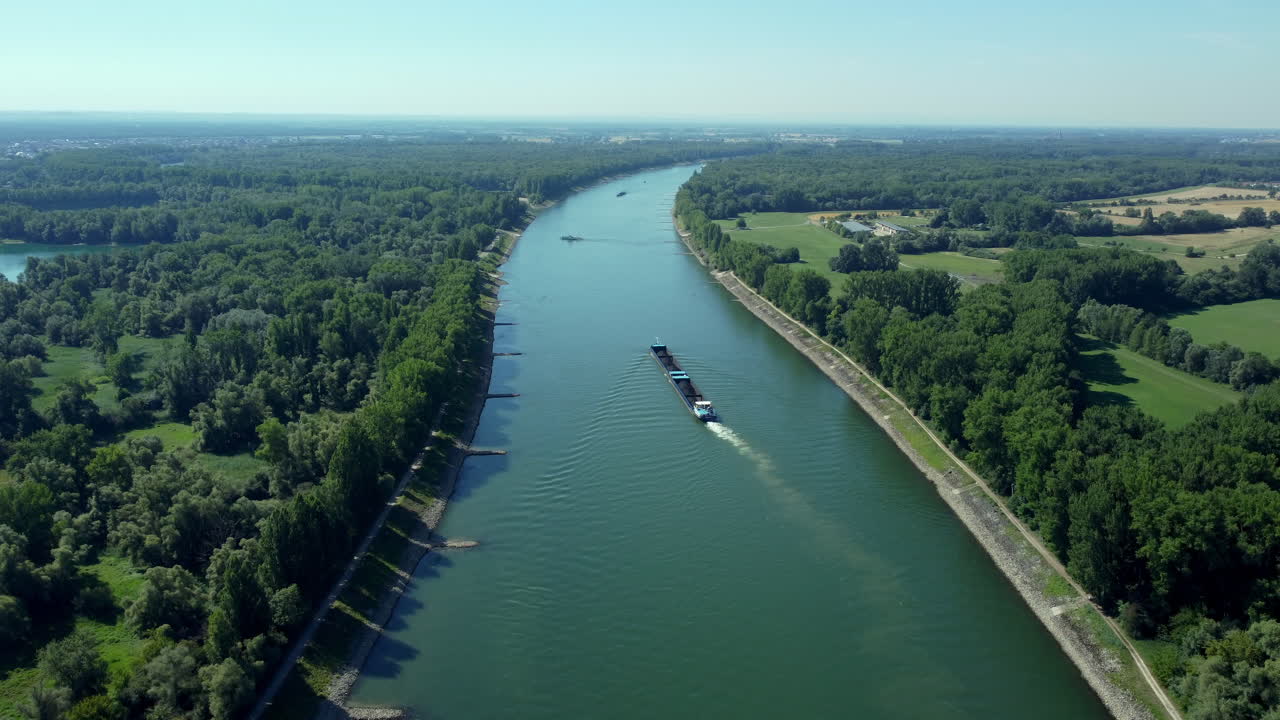 Aerial View of a Barge on a Canal Through Lush Green Landscapes