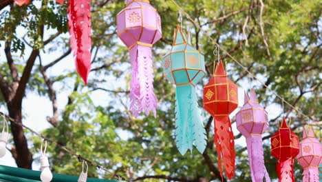 vibrant lanterns hanging outdoors in bangkok's lush park setting