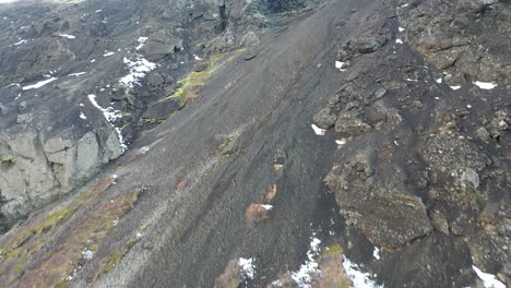 Aerial-moving-up-a-mountainous-slope-in-Thingvellir-National-Park-in-Iceland