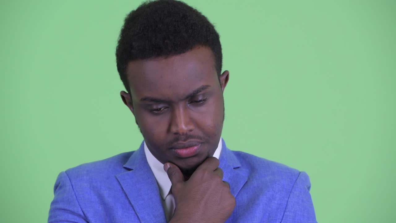 Young African businessman with Afro hair in suit