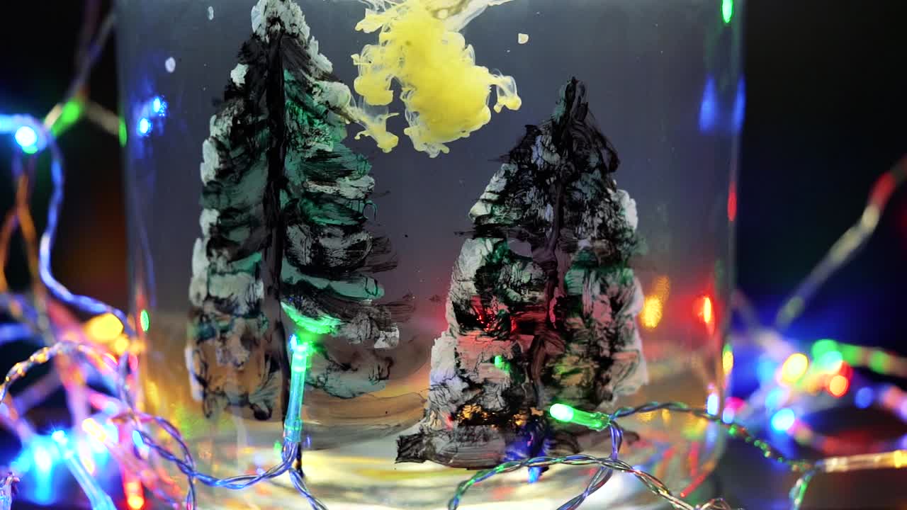 Colored paint floating in water tank surrounded by Christmas lights. Stable shot with the Sony a7iii