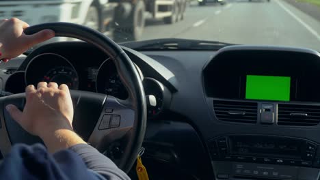 inside a car. a gps module is on. green screen