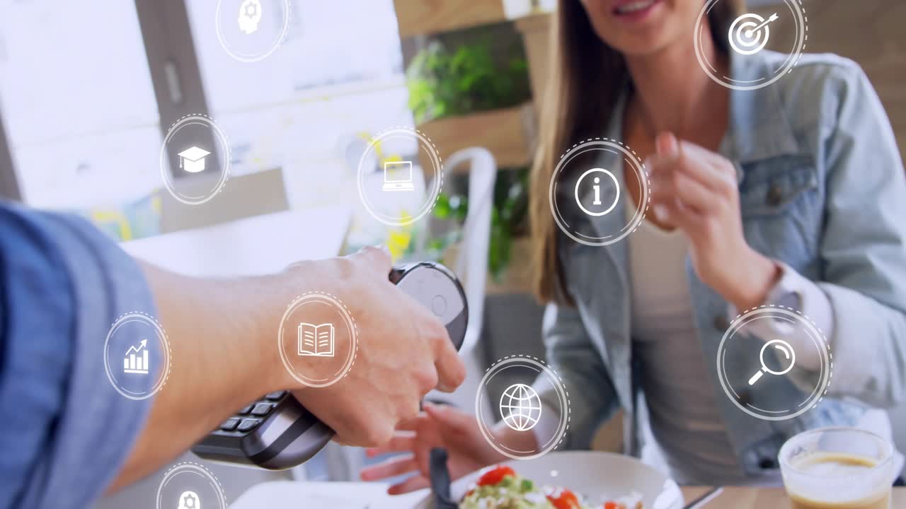 Male server holding terminal while female customer tapping to pay for meal, finance icons shifting