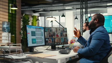 vertical video black analyst meeting on online video call with associates to discuss insights