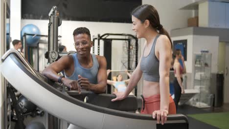 fitness instructor guiding client on treadmill