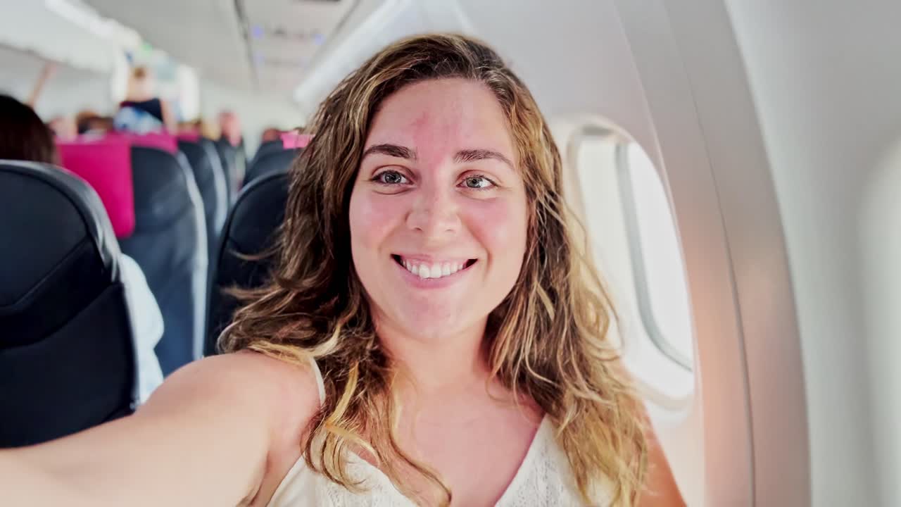 Woman on Airplane Seat, Smiling as Journey Begins