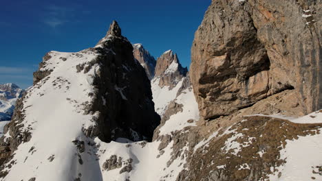 dynamic flythrough of towering snowy rocky mountain peaks set against a clear blue sky, capturing the essence of alpine adventure