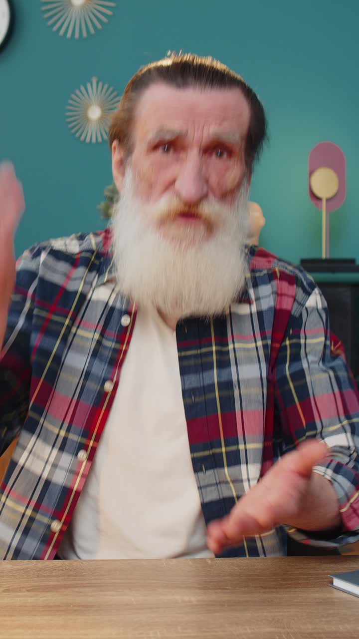 Conflict quarrel negotiation angry elderly man engaged in webcam online video call at home office