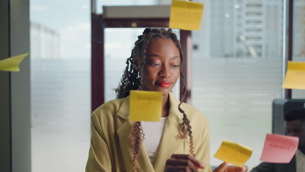 African American Business Woman Write Tasks Creative Ideas On Sticky Notes On Glass Board Female Corporate Leader Planning Project On Post It Sticky Notes Organize Work On Stickers