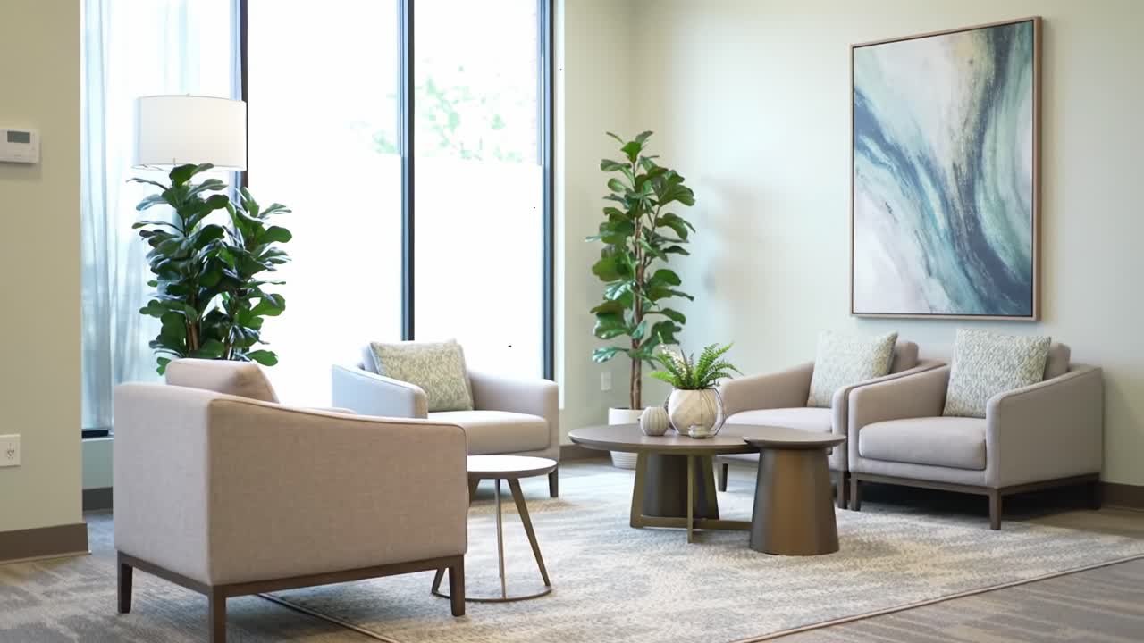 Stylish Interior Design of a Modern Waiting Room Featuring Cozy Seating, Elegant Decor, and Lush Greenery for a Calm Atmosphere