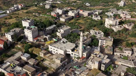 aerial view of a town with a prominent mosque and minaret